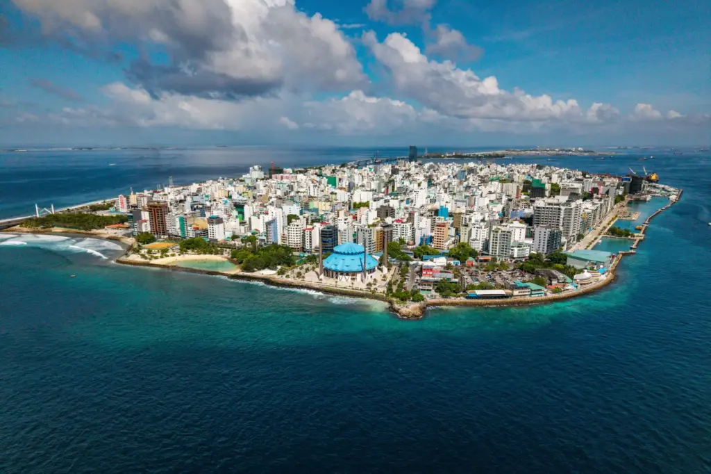 Buildings stand on Male, the capital city of the Maldives,...