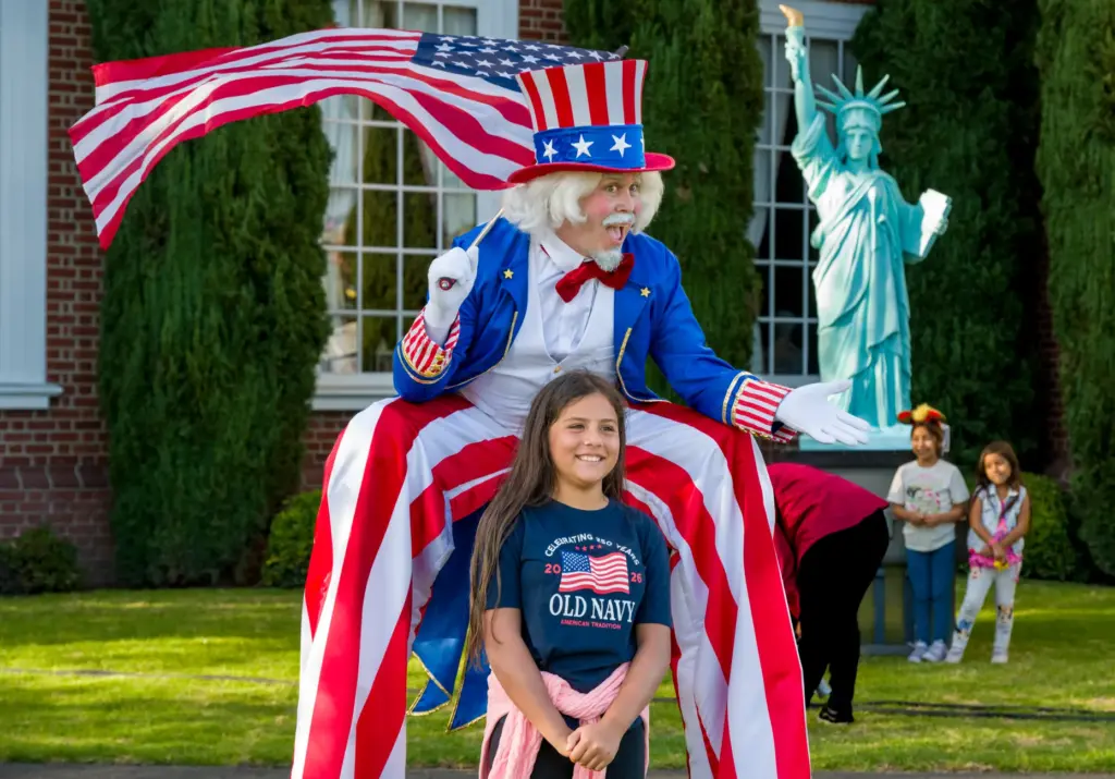 Peyton Morgan, 11, poses for a photo with stilt-walking Uncle...