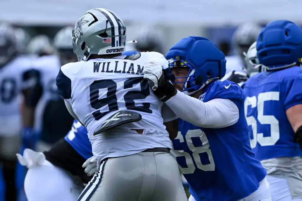 Rams offensive lineman David Quessenberry, right, defends against Dallas Cowboys...