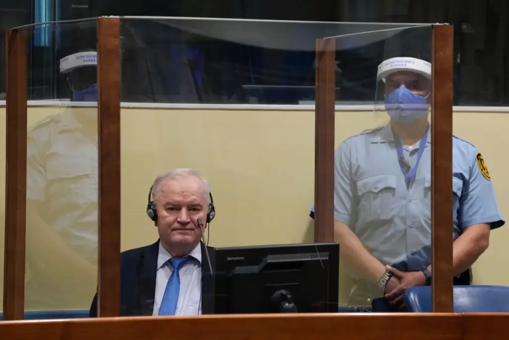 FILE – Former Bosnian Serb military chief Ratko Mladic sits...