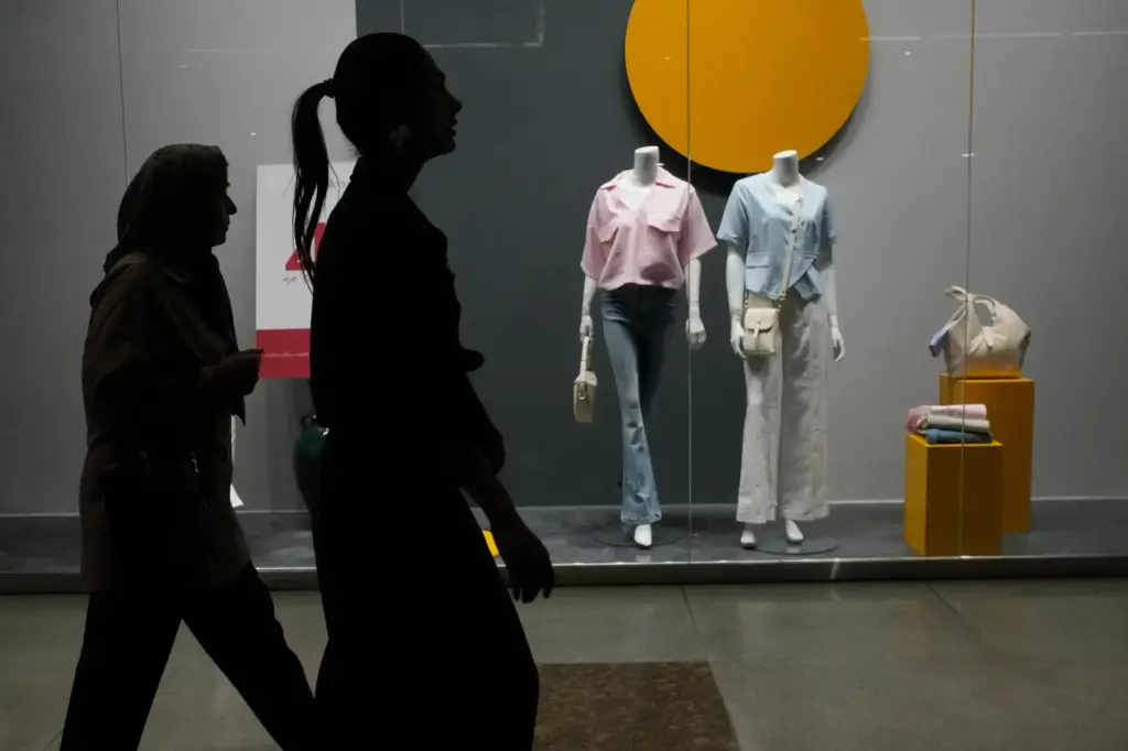 Women walk through the Iran Mall shopping center in Tehran,...