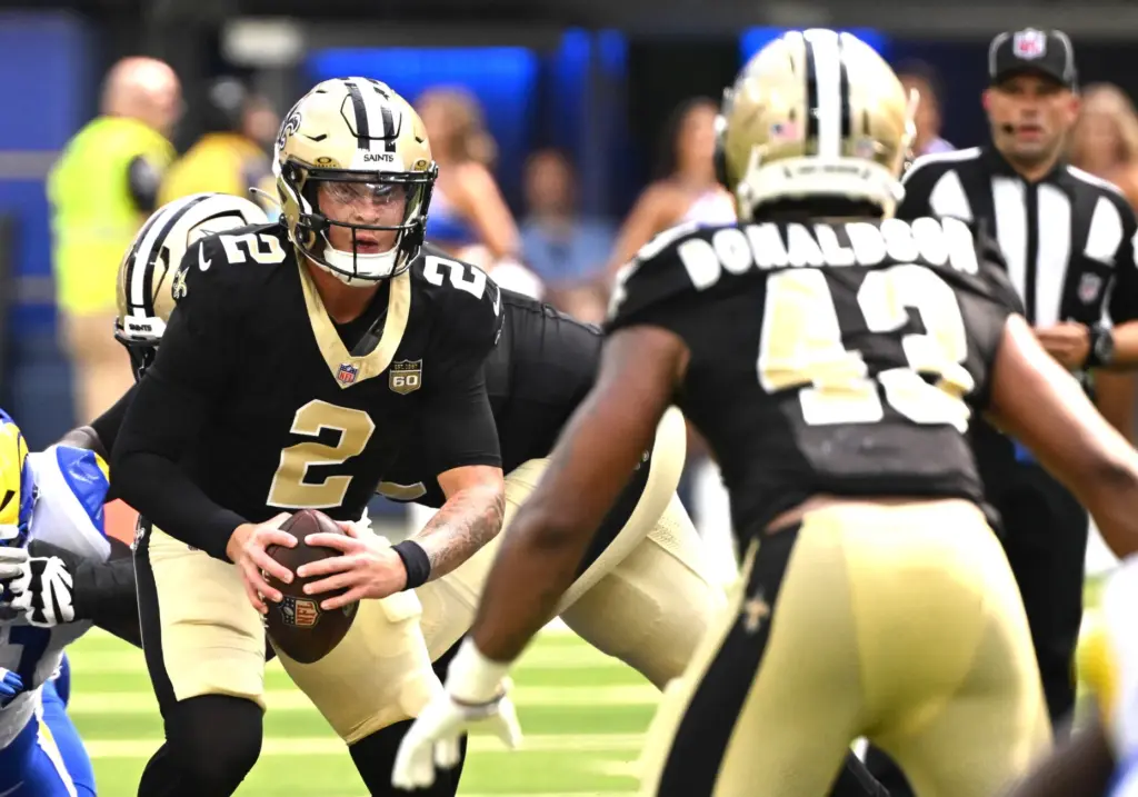 New Orleans Saints quarterback Spencer Rattler (2) shuffles toward running...