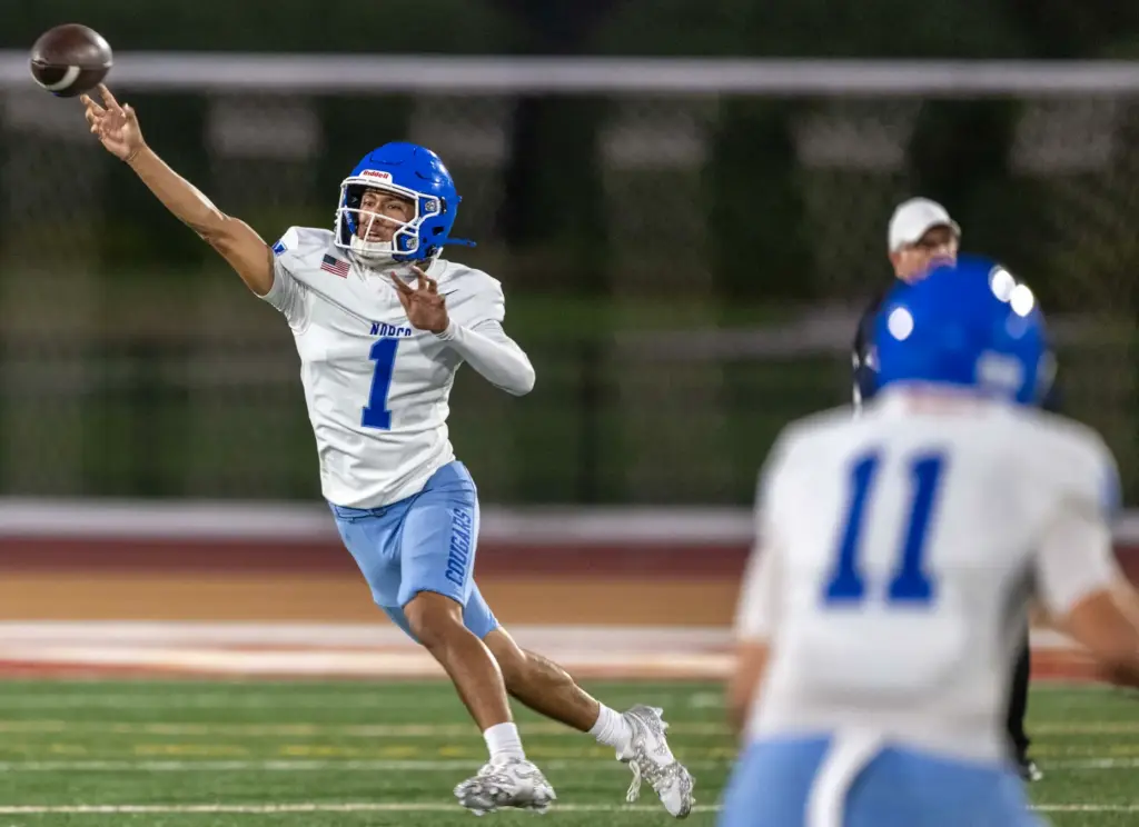 Norco quarterback Julian Medina (1) throws the ball while on...