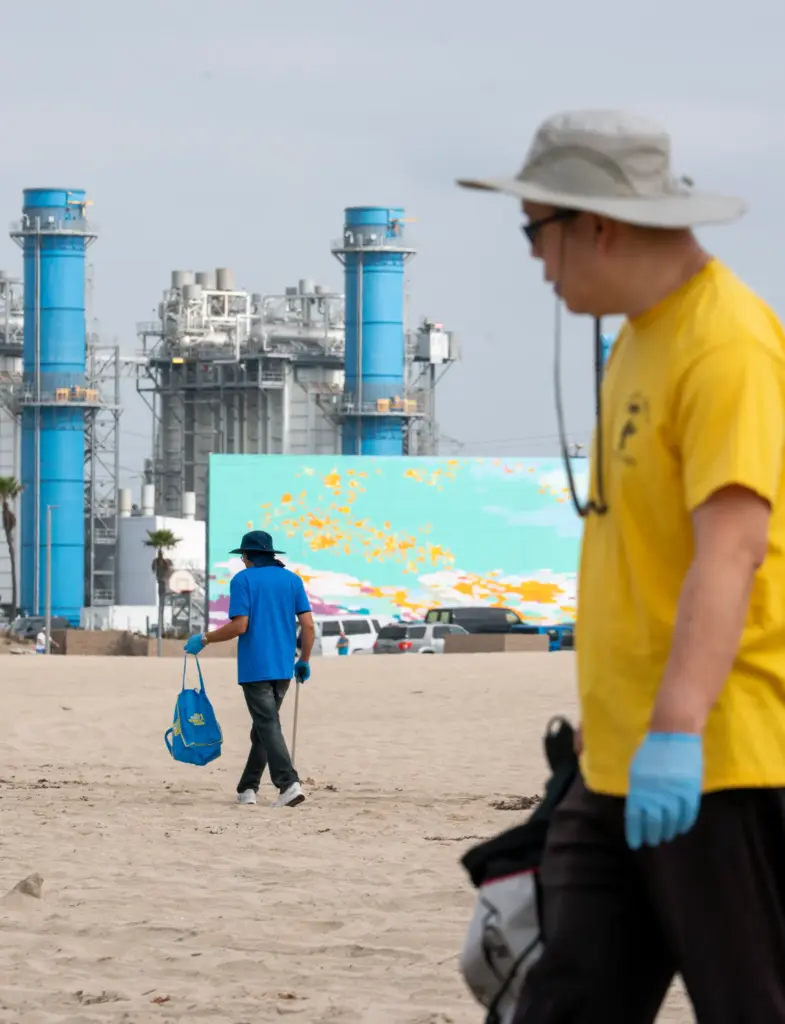 Danny Tran and Ari Pham search the sand for pollution...
