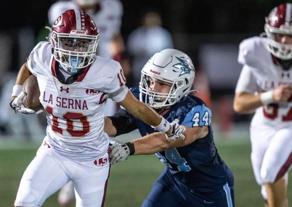 La Serna wide receiver Landon Armenta (10) carries the ball...