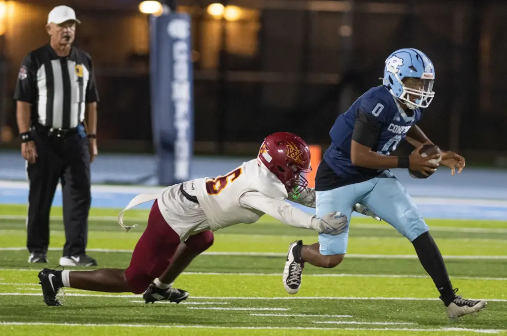 Long Beach Wilson’s Ashton Stokes tries to tackle Compton’s Donnie...