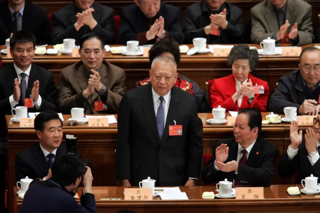FILE – Hong Kong Chief Executive Tung Chee-hwa stands to...