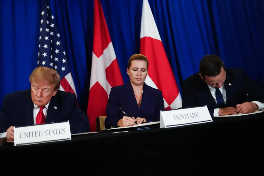 President Donald Trump signs a security agreement with Denmark's Prime Minister Mette Frederiksen and Greenland's Prime Minister Jens-Frederik Nielsen.