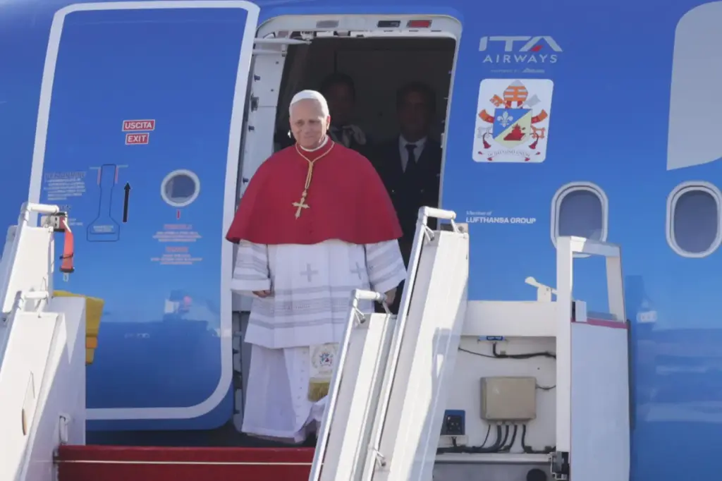 Pope Leo XIV steps off the plane at Paris Orly Airport.