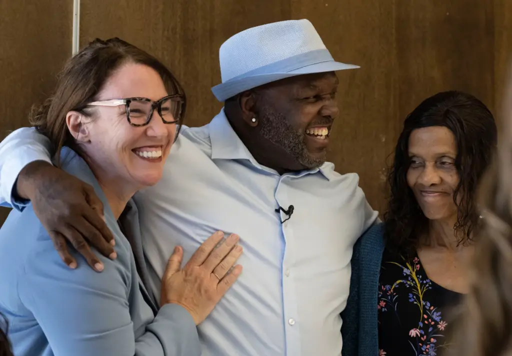 Guy Miles celebrates with Jasmin Harris, director of development and...