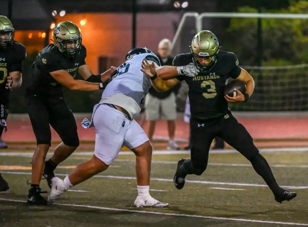 Mira Costa quarterback Wyatt Nucci rushes with the ball during...