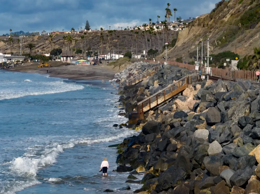 A beachgoer makes her way across north San Clemente, where...