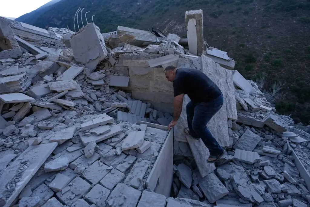 A man searches between the rubble of a destroyed house...