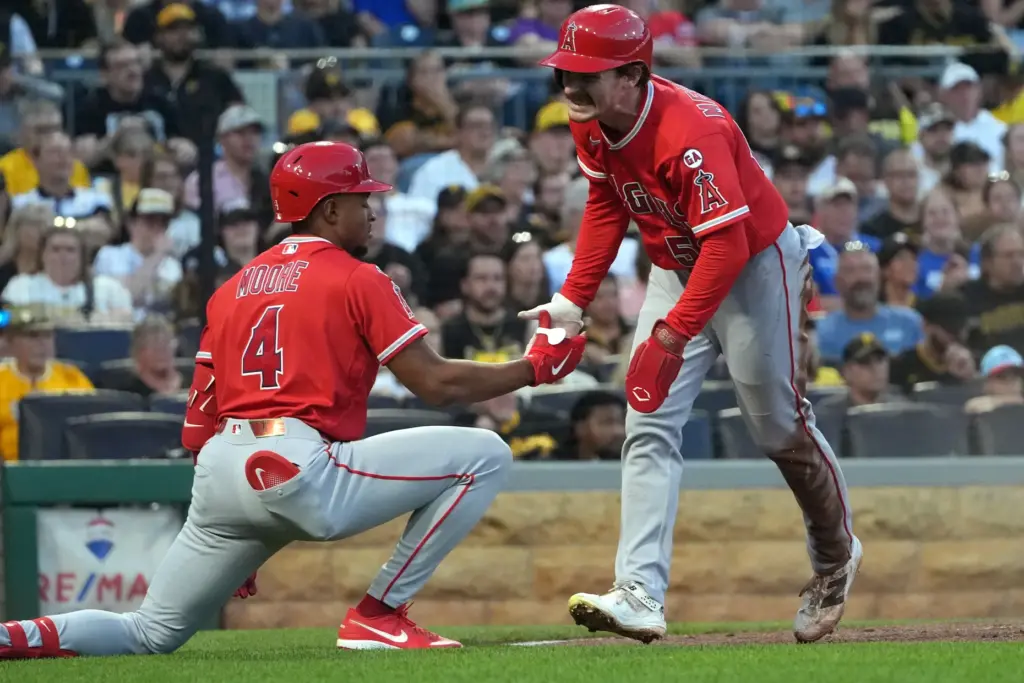 Angels’ Wade Meckler, right, celebrates with Christian Moore (4) after...