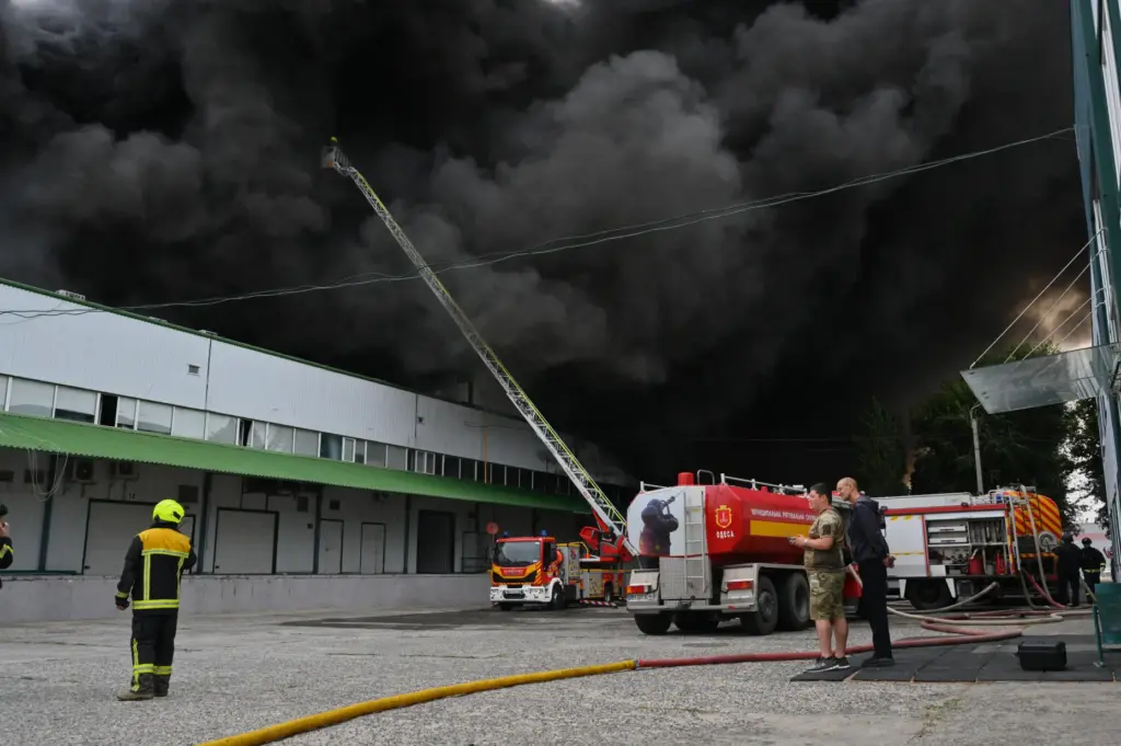 Firefighters put out a fire at warehouse stores after a...
