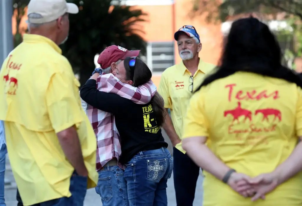 FILE – A member of Texas EquuSearch hugs Tim Miller,...