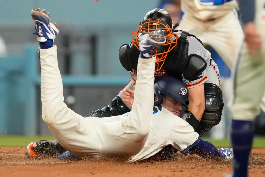 Dodgers’ Kyle Tucker, left, scores on a single by Tommy...