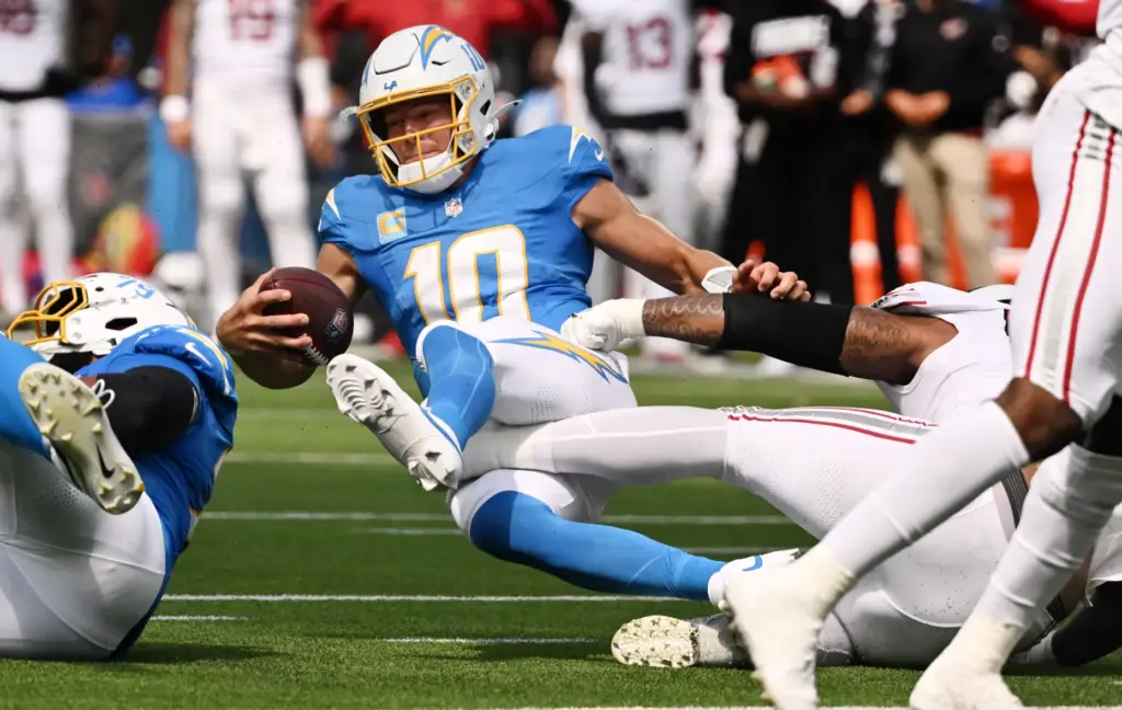 Chargers quarterback Justin Herbert (10) is sacked by Arizona Cardinals...