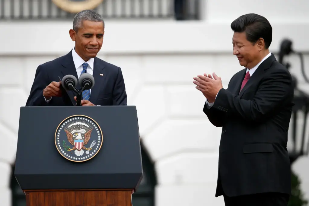 FILE – China’s President Xi Jinping applauds President Barack Obama...