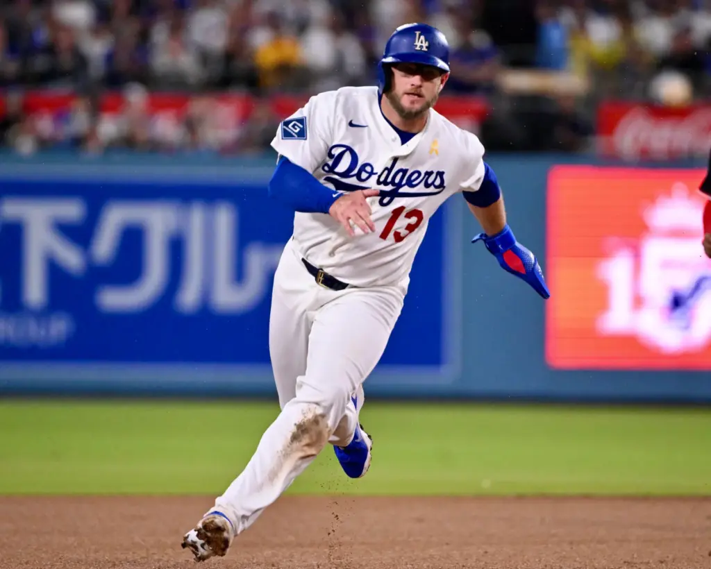Dodgers third baseman Max Muncy scores on an RBI double...