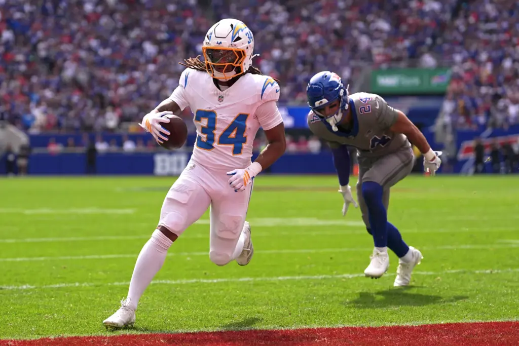 Chargers running back Keaton Mitchell (34) scores a touchdown ahead...