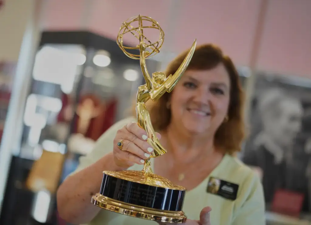 The Archbishop Fulton Sheen Museum tour coordinator, Rhonda Bachman, holds an Emmy award.