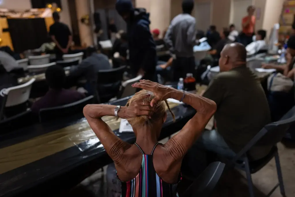 A woman in the audience fixes her hair before the...