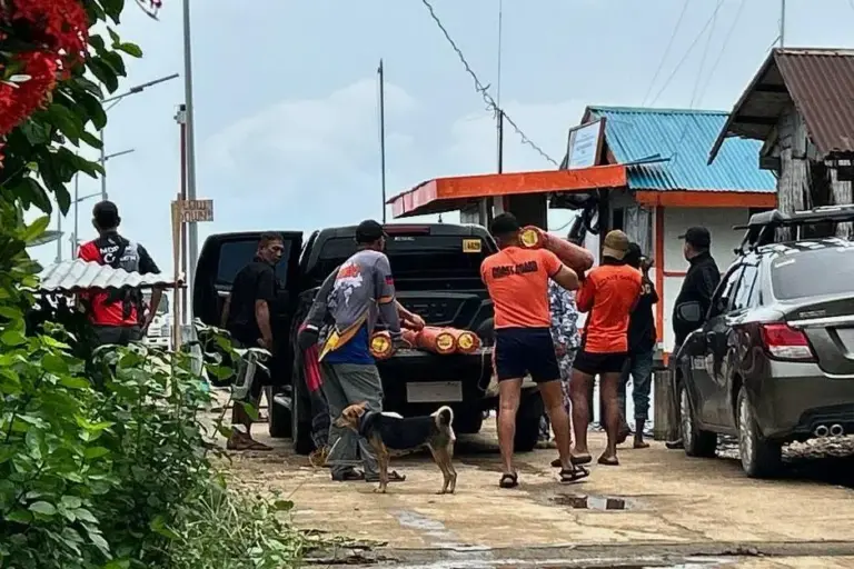 People prepare equipment to go out to sea from a...