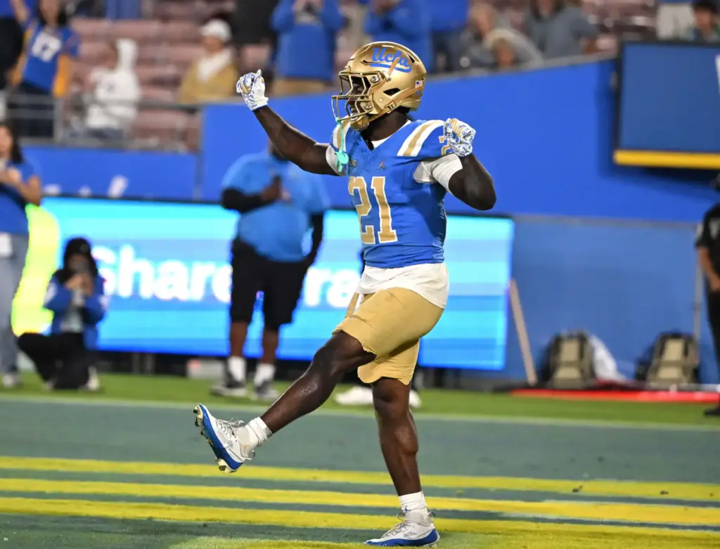 Running back Jaivian Thomas (21) of the UCLA Bruins reacts...