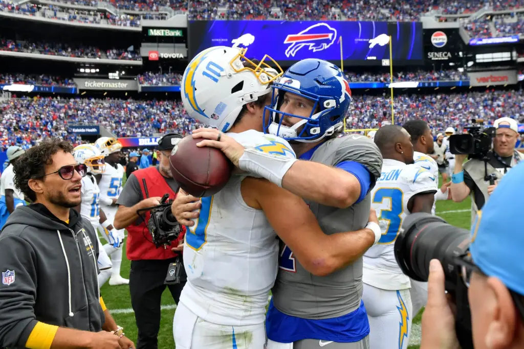 Chargers quarterback Justin Herbert, left, talks with Buffalo Bills quarterback...