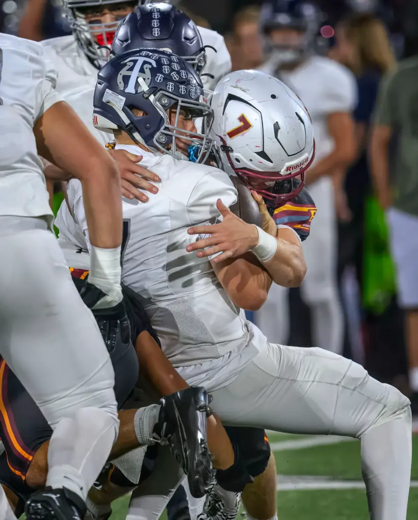 Trabuco Hills quarterback Jackson Verplancke is sacked by El Modena’s...
