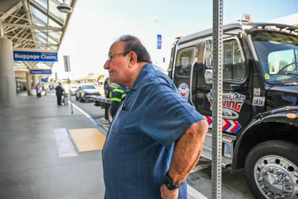 Fred Saca waits for an Uber ride as his car...