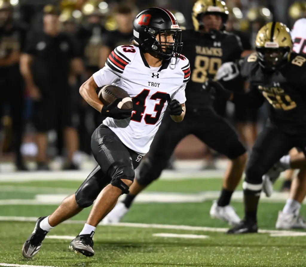 Running back Jordan Williams #43 of Troy rushes in the...