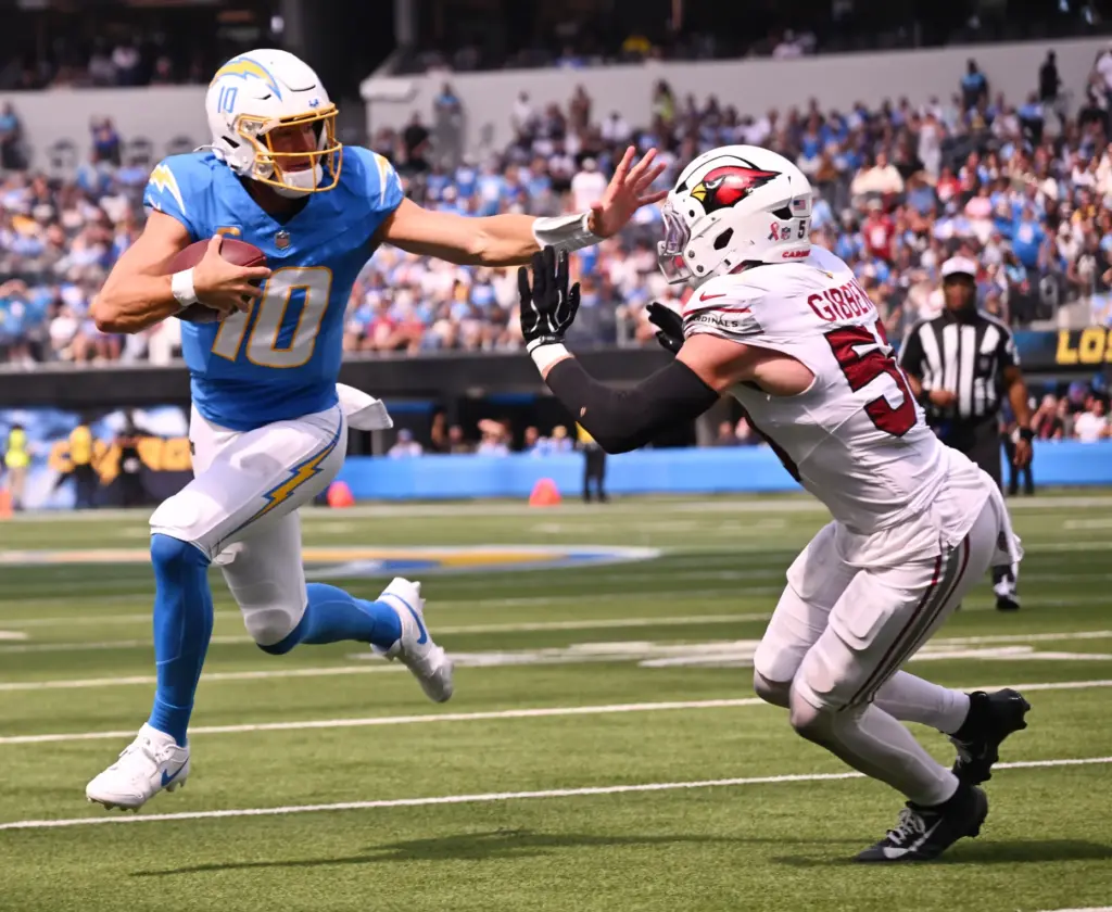 Chargers quarterback Justin Herbert (10) scrambles for yardage against Arizona...