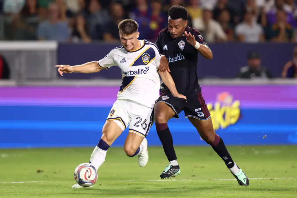 Galaxy defender Harbor Miller (26) vies for the ball with...