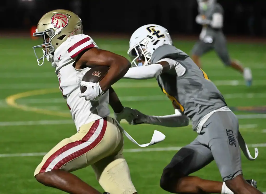 JSerraâs Clark Cokley (1) runs with the ball as Crean...