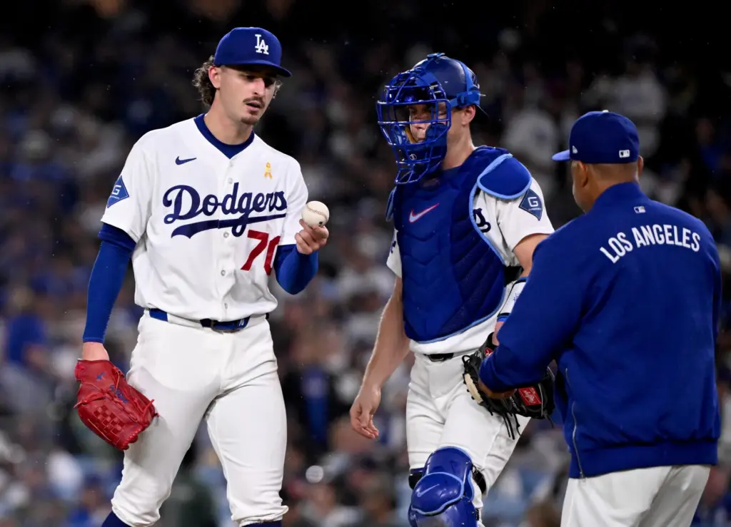 Dodgers manager Dave Roberts takes the ball from starting pitcher...