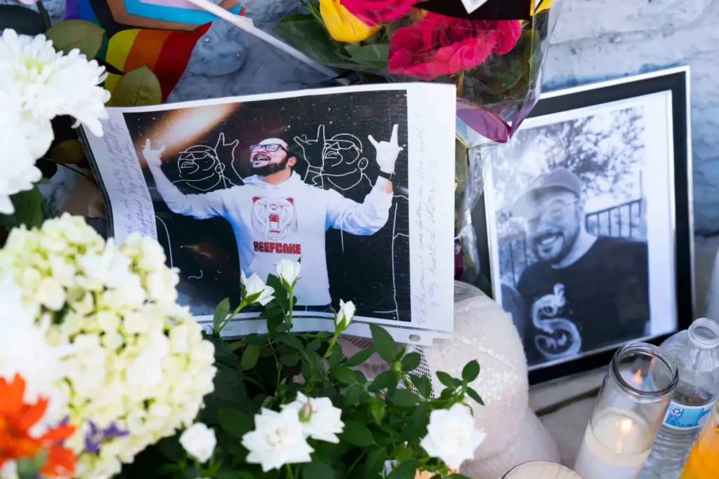 A growing memorial sits outside the Venture-N Bar in Tucson,...