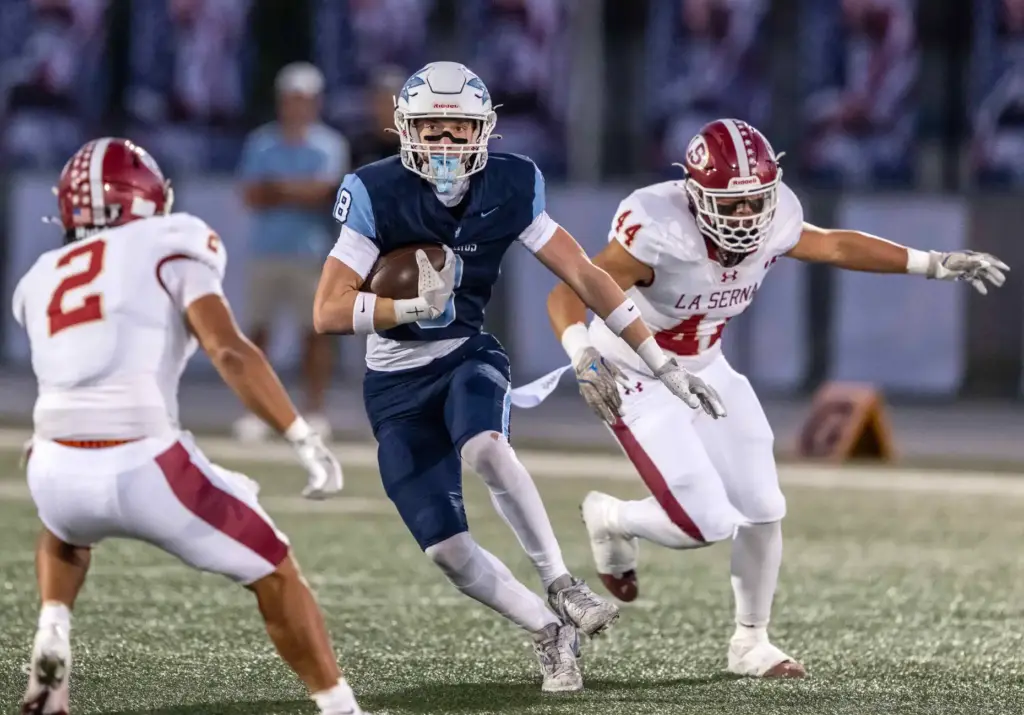 Corona del Mar wide receiver Nolan Scott (8) carries the...