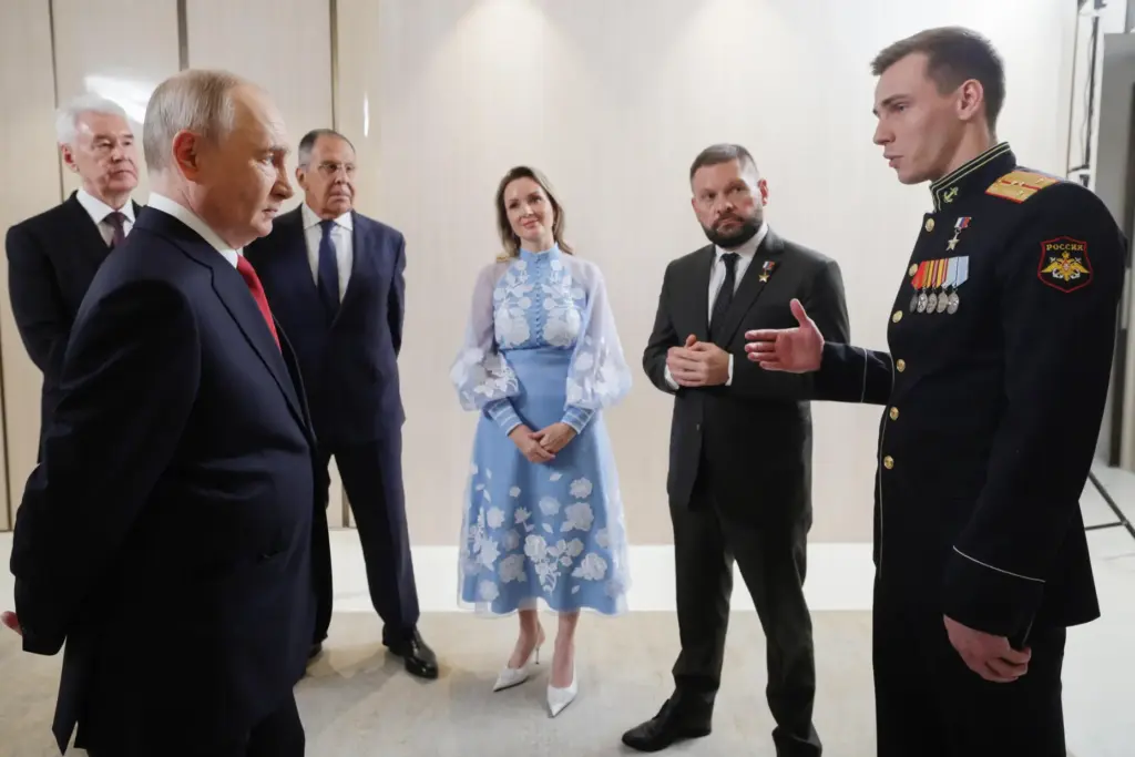 FILE – Russian President Vladimir Putin, foreground left, meets with...