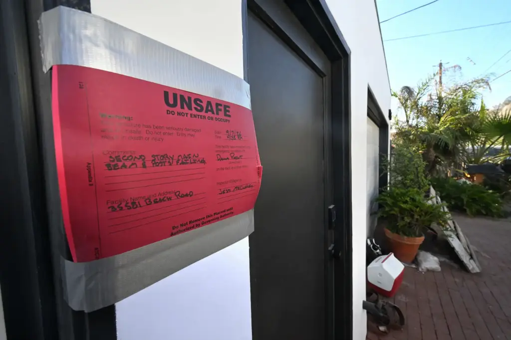 A home red tagged after waves damaged several homes near...