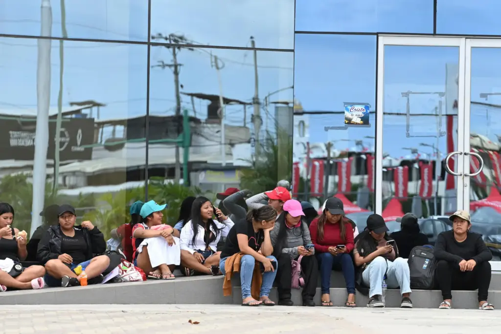 Women wait for information about the expected arrival of their relatives.