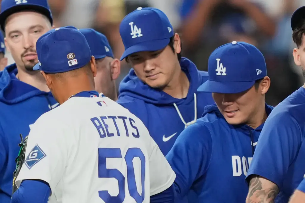 Dodgers’ Shohei Ohtani, center, and Yoshinobu Yamamoto, right, congratulate Mookie...