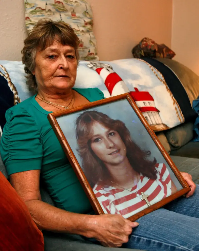 FILE – Jan Miller holds a photo of her daughter,...