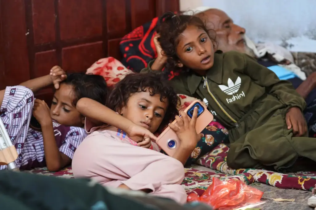 Displaced Yemenis rest at a temporary shelter in the Dar...