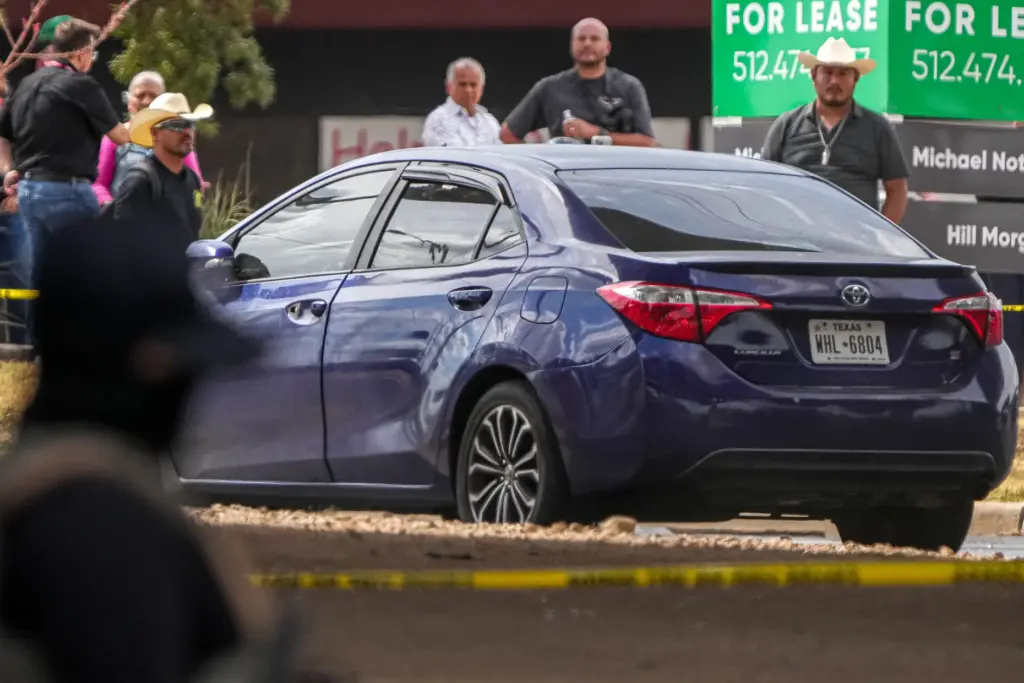 A vehicle is left in the street after a man was shot by ICE.
