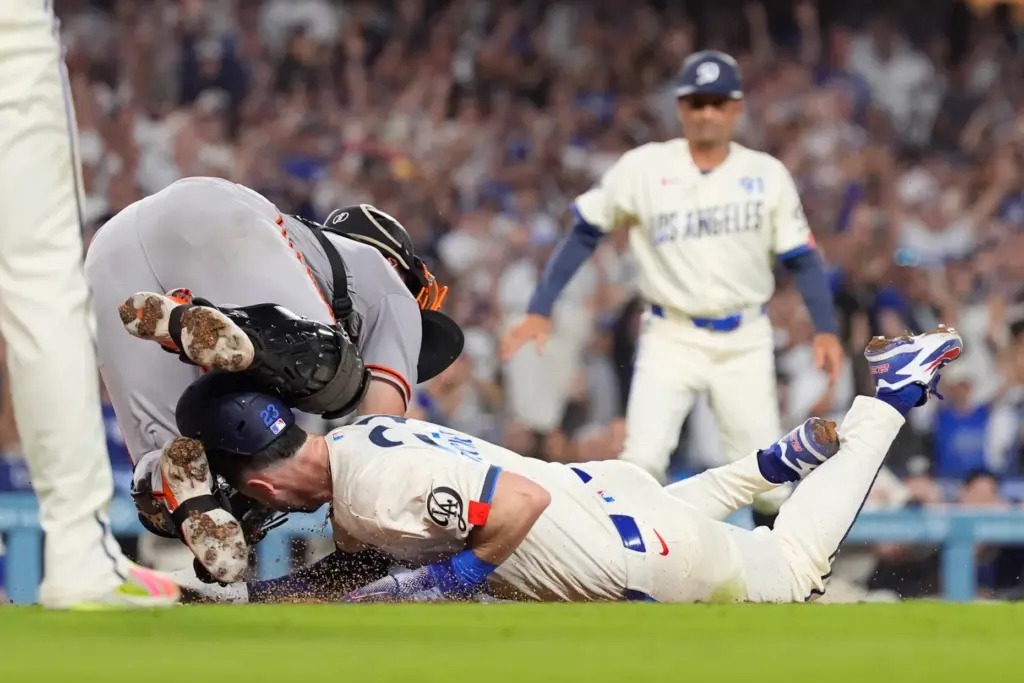 Dodgers’ Kyle Tucker, right, scores on a single by Tommy...