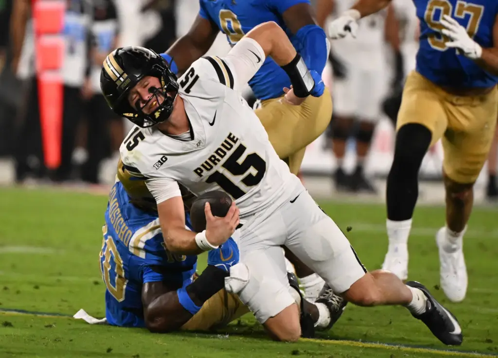 Linebacker Sammy Omosigho (10) of the UCLA Bruins sacks quarterback...