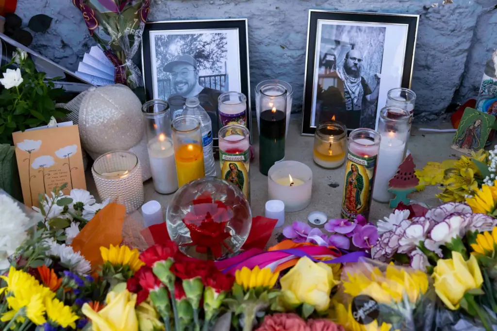 A growing memorial sits outside the Venture-N Bar in Tucson,...