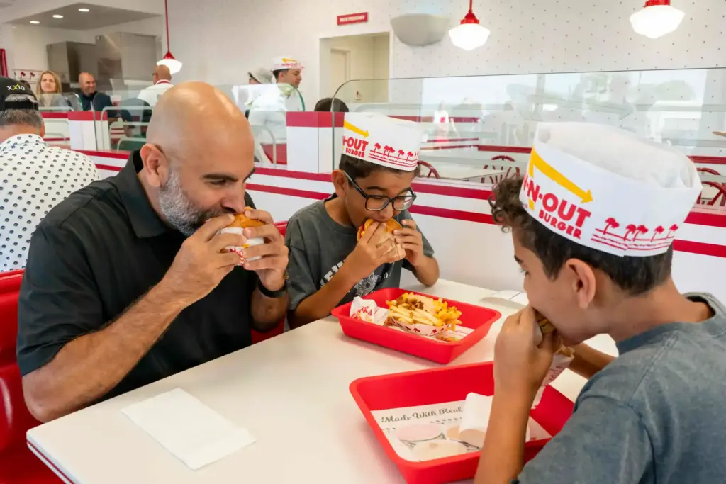 Amir Ghaneian and his sons, Adam and Zade, take some...